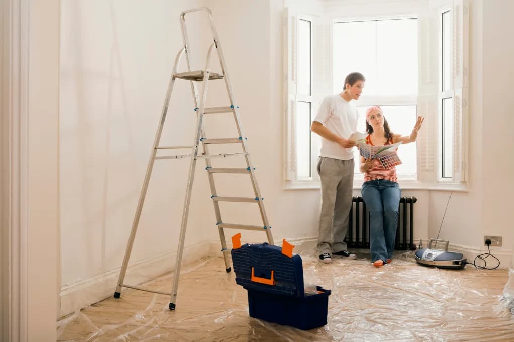 Two people discussing home renovations for a house they are trying to sell.