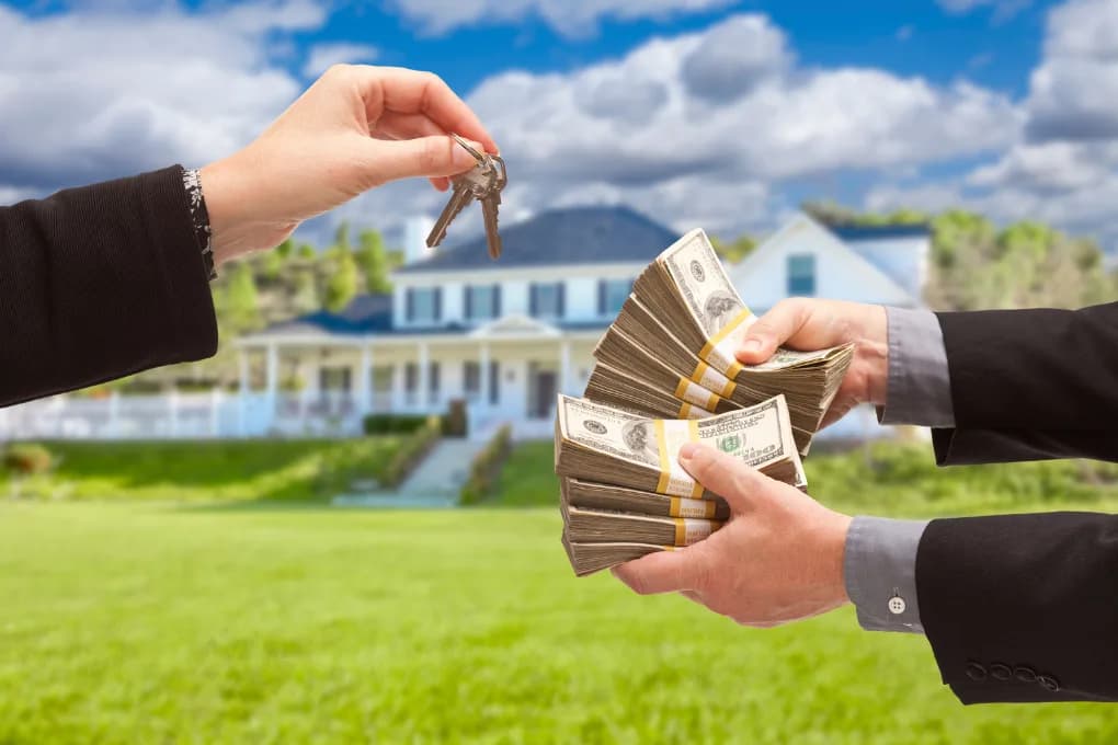 Homeowner handing over keys in exchange for a wad of cash.